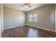 Bedroom with wood floors, ceiling fan, closet, and a window providing natural light at 2102 Lenoa Ln, Austell, GA 30106