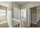 Upstairs hallway with a view into a bedroom with hardwood floors and ceiling fan at 2102 Lenoa Ln, Austell, GA 30106