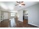 Open concept living area with hardwood floors, ceiling fan, and views into the kitchen at 2102 Lenoa Ln, Austell, GA 30106