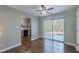 Bright living room with dark wood floors, ceiling fan, and sliding glass doors to a patio at 2102 Lenoa Ln, Austell, GA 30106