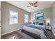 Staged bedroom with hardwood floors, natural light, and a serene blue color palette at 2102 Lenoa Ln, Austell, GA 30106