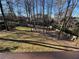 Picturesque backyard featuring mature trees, a storage shed, and fencing, creating a serene outdoor oasis at 6542 Cherry Tree Ln, Atlanta, GA 30328