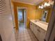 Bathroom featuring a single sink vanity, white tile floor and a view to an adjacent bathroom at 6542 Cherry Tree Ln, Atlanta, GA 30328