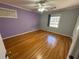 Bedroom with hardwood flooring, ceiling fan, window, and neutral paint at 6542 Cherry Tree Ln, Atlanta, GA 30328