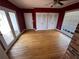 Bright bedroom featuring hardwood floors, three closets, and a ceiling fan at 6542 Cherry Tree Ln, Atlanta, GA 30328