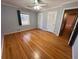 Bedroom with hardwood flooring, ceiling fan, window, and neutral paint at 6542 Cherry Tree Ln, Atlanta, GA 30328