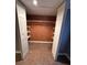 Walk-in closet with custom shelving and ample storage, featuring neutral tile flooring at 6542 Cherry Tree Ln, Atlanta, GA 30328