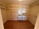 Walk-in closet with hardwood floors, shelving, and drawers for optimal storage at 6542 Cherry Tree Ln, Atlanta, GA 30328