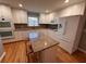 Modern kitchen features stainless steel appliances, granite countertops, a kitchen island and white cabinetry at 6542 Cherry Tree Ln, Atlanta, GA 30328