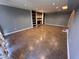 Finished basement area with a fireplace, built-in shelving, and tile flooring at 6542 Cherry Tree Ln, Atlanta, GA 30328