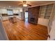 Spacious living room featuring hardwood floors, a brick fireplace, built-in shelves, and natural light from a large window at 6542 Cherry Tree Ln, Atlanta, GA 30328