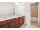 Bathroom featuring double vanity with wood cabinets and framed mirror at 11330 Easthaven Pl, Johns Creek, GA 30097