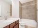 Bathroom featuring a modern vanity, bathtub, and tiled walls at 11330 Easthaven Pl, Johns Creek, GA 30097