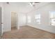 Large carpeted bedroom with natural light, a ceiling fan and walk in closet at 11330 Easthaven Pl, Johns Creek, GA 30097