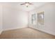 Carpeted bedroom featuring a ceiling fan and one window with blinds at 11330 Easthaven Pl, Johns Creek, GA 30097