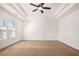 Bright and airy bedroom with neutral carpet, ceiling fan and large window at 11330 Easthaven Pl, Johns Creek, GA 30097