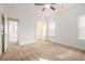 Carpeted bedroom featuring a ceiling fan and two windows with blinds at 11330 Easthaven Pl, Johns Creek, GA 30097