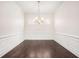 Bright dining room with dark wood floors, wainscoting, and elegant chandelier at 11330 Easthaven Pl, Johns Creek, GA 30097