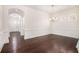 Formal dining room featuring hardwood floors, wainscoting, and elegant chandelier at 11330 Easthaven Pl, Johns Creek, GA 30097