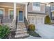 Charming brick home featuring a two-car garage and welcoming stone stairway to the porch at 11330 Easthaven Pl, Johns Creek, GA 30097