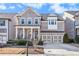 Traditional brick home featuring a two-car garage and welcoming front porch at 11330 Easthaven Pl, Johns Creek, GA 30097