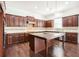 Spacious kitchen featuring an island, stainless steel appliances, and dark wood cabinetry at 11330 Easthaven Pl, Johns Creek, GA 30097