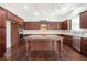 A spacious kitchen with dark wood cabinets and island and stainless steel appliances at 11330 Easthaven Pl, Johns Creek, GA 30097