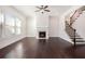 Inviting living room featuring hardwood floors, fireplace, and staircase at 11330 Easthaven Pl, Johns Creek, GA 30097