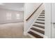 A cozy staircase with hardwood steps and railing leads to the upper level of this well-lit home at 11330 Easthaven Pl, Johns Creek, GA 30097