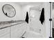 Modern bathroom featuring white vanity, granite countertop, glass shower, and black-and-white tile floors at 1406 Winston Pl, Decatur, GA 30033