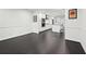 Dining room with wainscoting, dark wood floors and white walls is bright and open to kitchen at 1406 Winston Pl, Decatur, GA 30033