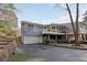 Back exterior showcasing a charming home with a balcony and a two-car garage with paved driveway at 1406 Winston Pl, Decatur, GA 30033