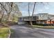 Rear exterior view of the property features a balcony, two-car garage, and a lengthy driveway at 1406 Winston Pl, Decatur, GA 30033