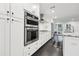 Modern kitchen with stainless steel appliances, sleek cabinetry, and dark hardwood floors at 1406 Winston Pl, Decatur, GA 30033