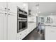 Bright kitchen features stainless steel appliances, white cabinetry, and granite countertops at 1406 Winston Pl, Decatur, GA 30033