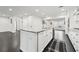 Kitchen island features stainless steel appliances, granite countertops and dark hardwood floors at 1406 Winston Pl, Decatur, GA 30033