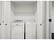 Well-lit laundry closet with washer and dryer behind bifold doors offers in-house convenience at 1406 Winston Pl, Decatur, GA 30033