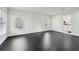 Bright living room featuring dark wood floors, white walls, with three windows at 1406 Winston Pl, Decatur, GA 30033