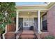 Inviting front porch with brick steps, black railing, and classic columns at 1406 Winston Pl, Decatur, GA 30033