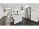 Bright kitchen featuring an island, stainless steel appliances, white cabinetry and dark wood floors at 1406 Winston Pl, Decatur, GA 30033