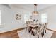 Dining room with hardwood floors, modern lighting, and a table set for a meal at 1824 Westwood Sw Ave, Atlanta, GA 30310