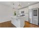 Bright kitchen features white cabinets, stainless steel appliances, and a center island with breakfast bar at 1824 Westwood Sw Ave, Atlanta, GA 30310