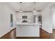 Bright kitchen features white cabinetry, stainless steel appliances, quartz counters, and an island at 1824 Westwood Sw Ave, Atlanta, GA 30310