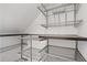 Organized walk-in closet with metal shelves and a wooden shelf at 1824 Westwood Sw Ave, Atlanta, GA 30310