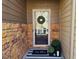 Cozy front door entrance with decorative wreath, striped rug and potted plants at 2613 Stonekey Bnd, Lithonia, GA 30058