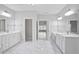 Elegant bathroom features double vanities, marble floors, and access to other rooms, offering convenience and style at 4335 Hastings Dr, Cumming, GA 30041