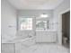 Spacious bathroom with marble floors, a soaking tub, and a vanity, combining luxury and practicality at 4335 Hastings Dr, Cumming, GA 30041