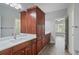 Bathroom vanity with double sinks, granite countertop, and wooden cabinets at 4335 Hastings Dr, Cumming, GA 30041