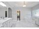 Luxurious bathroom features marble tile floors, a soaking tub, and a glass-enclosed shower for a spa-like experience at 4335 Hastings Dr, Cumming, GA 30041