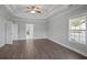 Bright bedroom featuring wood-look floors, a tray ceiling, and a window, creating a serene and inviting atmosphere at 4335 Hastings Dr, Cumming, GA 30041